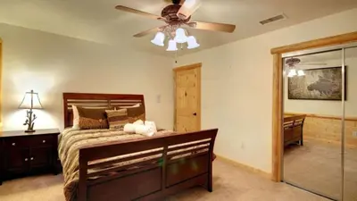 a bedroom with a bed and a ceiling fan at Starlight Retreat by AvantStay Gorgeous Log Style Home w Incredible Views in Big Bear Lake
