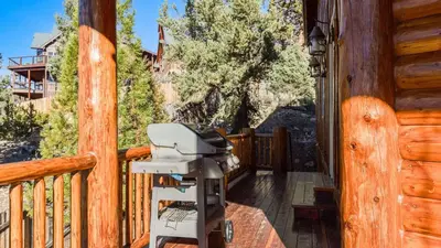 a camera on the porch of a cabin at Starlight Retreat by AvantStay Gorgeous Log Style Home w Incredible Views in Big Bear Lake