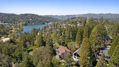 an aerial view of a house next to a lake at Hot Tub Fire Pit Deck Views Near the Lake The Matterhorn Manor by AvantStay in Crestline