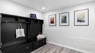 a room with black cabinets and pictures on the wall at Hot Tub Fire Pit Deck Views Near the Lake The Matterhorn Manor by AvantStay in Crestline