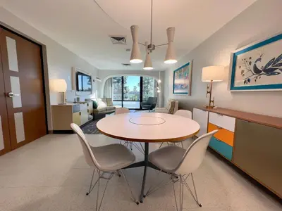 a dining room and living room with a table and chairs at Howard Johnson by Wyndham Anaheim Hotel and Water Playground in Anaheim
