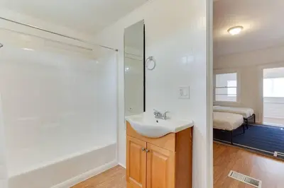 a white bathroom with a sink and a shower at 5 Bedroom Koreatown Charmer near DTLA in Los Angeles