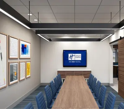 a conference room with a long table and blue chairs at Holiday Inn Express & Suites Ridgecrest - China Lake by IHG in Ridgecrest