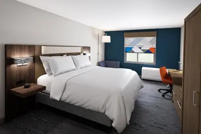 a bedroom with a large white bed and a desk at Holiday Inn Express & Suites Ridgecrest - China Lake by IHG in Ridgecrest