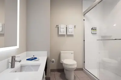 a white bathroom with a toilet and a shower at Holiday Inn Express & Suites Ridgecrest - China Lake by IHG in Ridgecrest