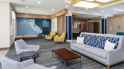 a lobby with a couch and chairs and a table at Holiday Inn Express & Suites Ridgecrest - China Lake by IHG in Ridgecrest