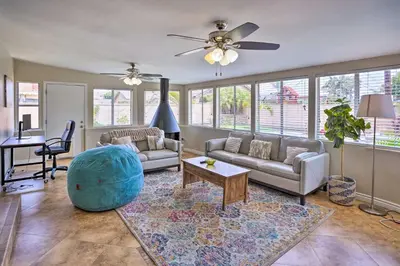 a living room with a couch and a table at Quiet Anaheim Home with Pool, 5 Mi to Disney! in Anaheim