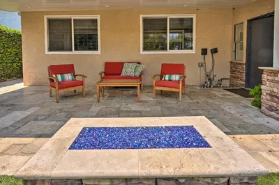 two chairs and a table on a patio at Quiet Anaheim Home with Pool, 5 Mi to Disney! in Anaheim