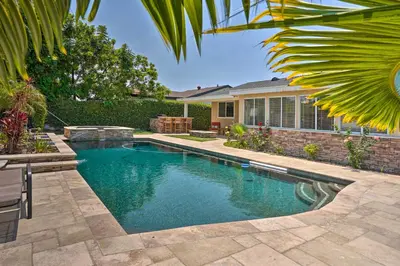 a swimming pool in the backyard of a house at Quiet Anaheim Home with Pool, 5 Mi to Disney! in Anaheim