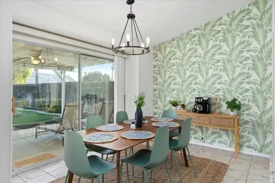 a dining room with a table and chairs at Revitalizing 3 Bedroom Home With Pool, Pet-Friendly, Wi-fi in Bakersfield