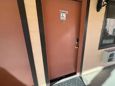 a door with a sign on it next to a building at Frazier View Motel in Frazier Park