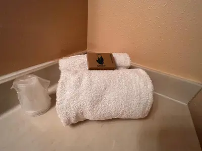 a bathroom with a white towel and a box on it at Frazier View Motel in Frazier Park