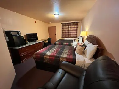 a hotel room with a bed and a couch and a television at Frazier View Motel in Frazier Park