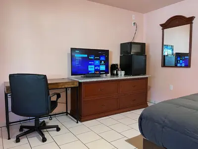 a bedroom with a desk with a computer and a chair at Frazier View Motel in Frazier Park