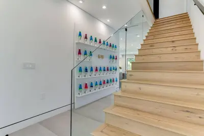 a staircase in a house with wooden floors at Posh Luxury Modern Home with Pool Spa and Rooftop Deck in Encino