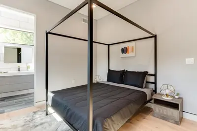 a bedroom with a canopy bed in a room at Posh Luxury Modern Home with Pool Spa and Rooftop Deck in Encino