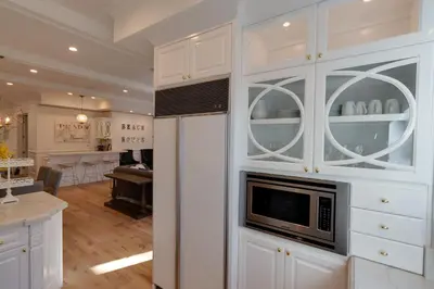a kitchen with white cabinets with a microwave at Beautiful 2 Story Right by the Water, Ocean View in Long Beach