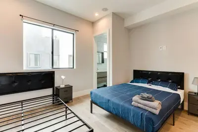 a bedroom with a blue bed and a large window at Luxury Modern 4 bedroom 3 Bath Home With Rooftop Deck #3 in Los Angeles