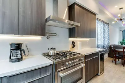 a kitchen with a stove top oven next to a counter at Luxury Modern 4 bedroom 3 Bath Home With Rooftop Deck #3 in Los Angeles