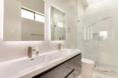 a white bathroom with a sink and a toilet at Luxury Modern 4 bedroom 3 Bath Home With Rooftop Deck #3 in Los Angeles