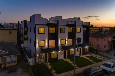 an aerial view of a building at sunset at 2 Luxury Modern 8 Bedroom Home with Rooftop Decks in Los Angeles