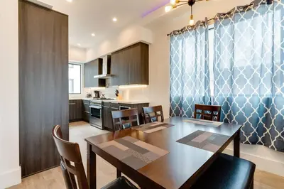 a kitchen and dining room with a table and chairs at 2 Luxury Modern 8 Bedroom Home with Rooftop Decks in Los Angeles