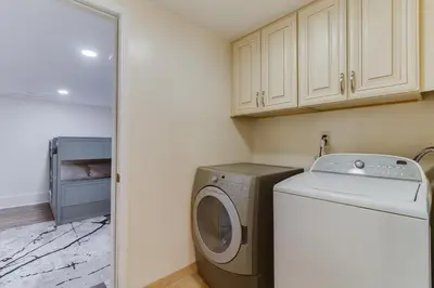 a laundry room with a washing machine and a washer at 4 Bedroom West Hills Charmer with Pool and Jacuzzi in Los Angeles
