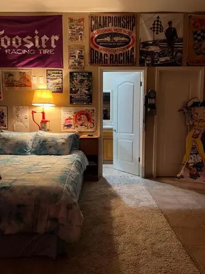 a bedroom with a bed and posters on the wall at My Oasis in Bakersfield