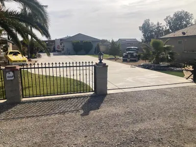 a gate in front of a driveway with a parking lot at My Oasis in Bakersfield