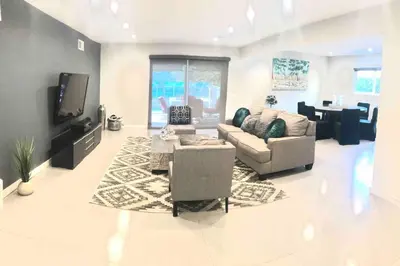 a living room with a couch and a tv at Luxury house pool & Spa 10 mins from Hollywood & Universal Studios in Los Angeles