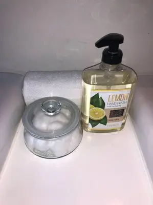 a bottle of lemon essential oil and a container of soap at Luxury house pool & Spa 10 mins from Hollywood & Universal Studios in Los Angeles