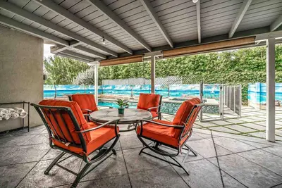 a patio with a table and chairs and a pool at Luxury house pool & Spa 10 mins from Hollywood & Universal Studios in Los Angeles