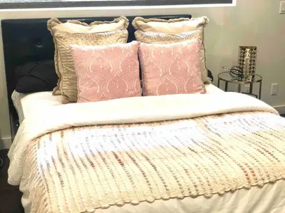 a bed with several pillows on top of it at Luxury house pool & Spa 10 mins from Hollywood & Universal Studios in Los Angeles