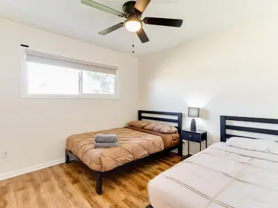 a bedroom with two beds and a ceiling fan at 5 Bedroom Charmer in Granada Hills in Granada Hills