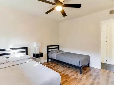 a bedroom with two beds and a ceiling fan at 5 Bedroom Charmer in Granada Hills in Granada Hills