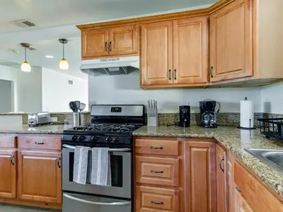 a kitchen with wooden cabinets and a stove at 5 Bedroom Charmer in Granada Hills in Granada Hills