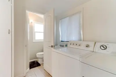 a white bathroom with a sink and a toilet at Valley Modern Glam Charmer in Reseda