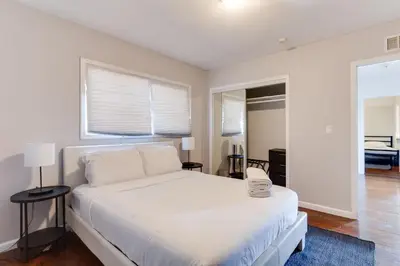 a white bedroom with a white bed and a window at Valley Modern Glam Charmer in Reseda