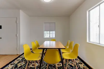 a conference room with a table and yellow chairs at New 4 bedroom Modern Villa in Mar Vista in Los Angeles