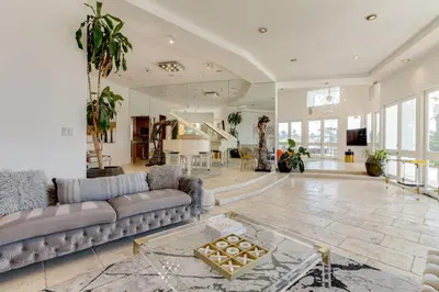 a living room with a couch and a table at Beverly Hills City View Mansion in Los Angeles