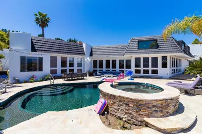 a home with a swimming pool and a house at Beverly Hills City View Mansion in Los Angeles
