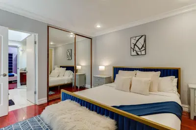 a bedroom with a large bed and a mirror at Beverly Hills City View Mansion in Los Angeles