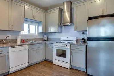 a kitchen with white cabinets and white appliances at Cozy 3 bedroom San Fernando Valley in San Fernando