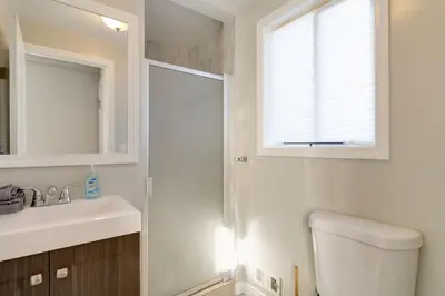 a bathroom with a toilet and a sink and a window at Cozy 3 bedroom San Fernando Valley in San Fernando