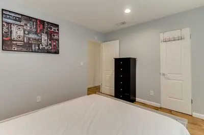a bedroom with a bed and a black dresser at 4 bedroom house with a pool in Reseda