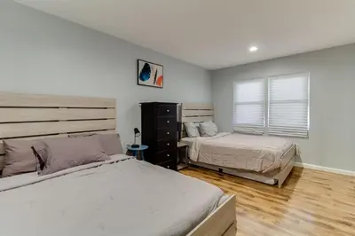 a bedroom with two beds and a window at 4 bedroom house with a pool in Reseda