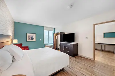 a hotel room with a bed and a flat screen tv at Home2 Suites By Hilton San Bernardino in San Bernardino