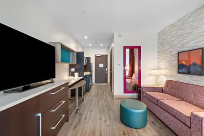a living room with a couch and a flat screen tv at Home2 Suites By Hilton San Bernardino in San Bernardino