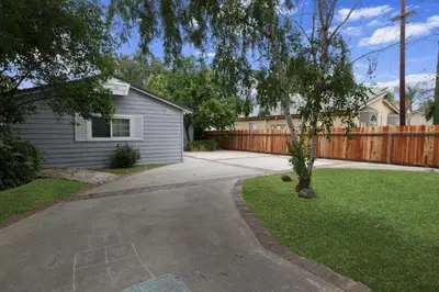 a driveway in front of a house with a fence at Woodland Hills Zen Modern in Woodland Hills