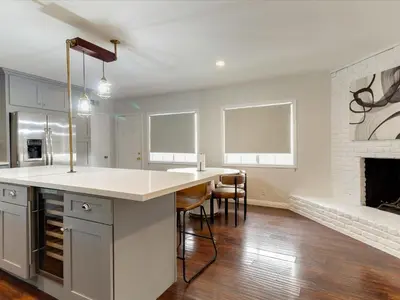 a kitchen with a white counter and a fireplace at Woodland Hills Zen Modern in Woodland Hills